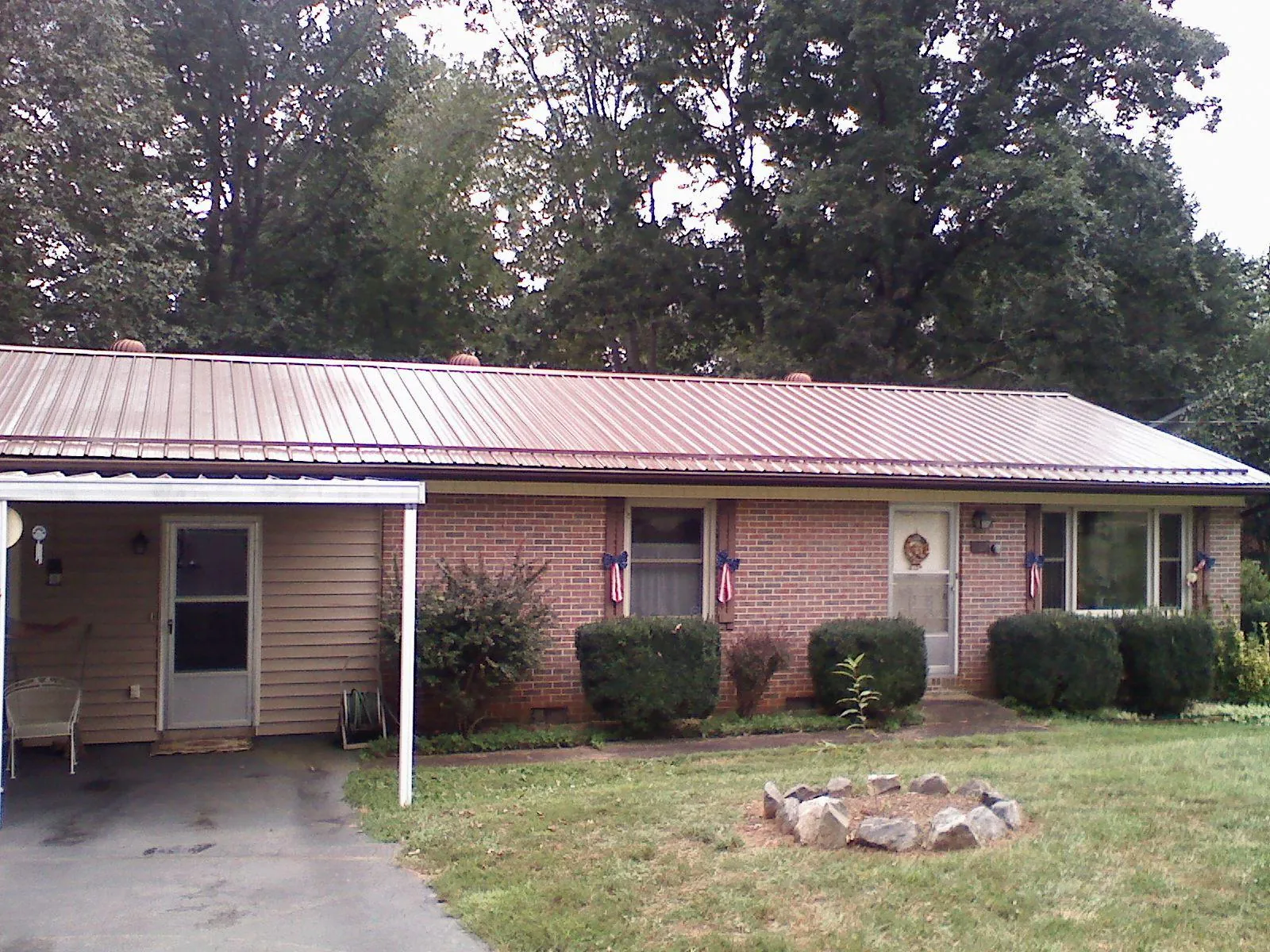 Bronze metal roof and carport on a brick ranch home — Roof Repair work by our crew in Feura Bush